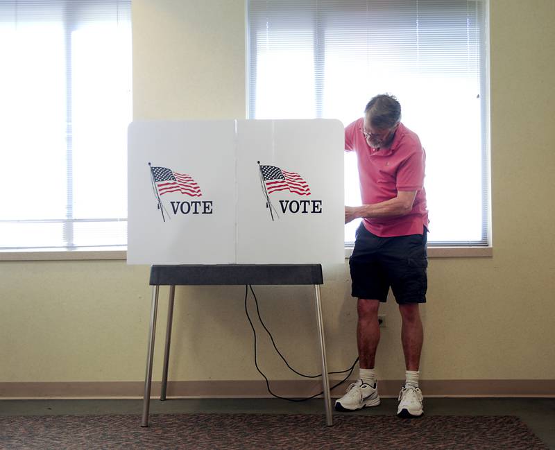 Election Judge Steve Krause opens up the voting machines Friday, June 24, 2022, at the McHenry County Administration Building, 667 Ware Road in Woodstock. Polls are open from 6 a.m until 7 p.m. today for people to cast their ballot in the in the primary election.