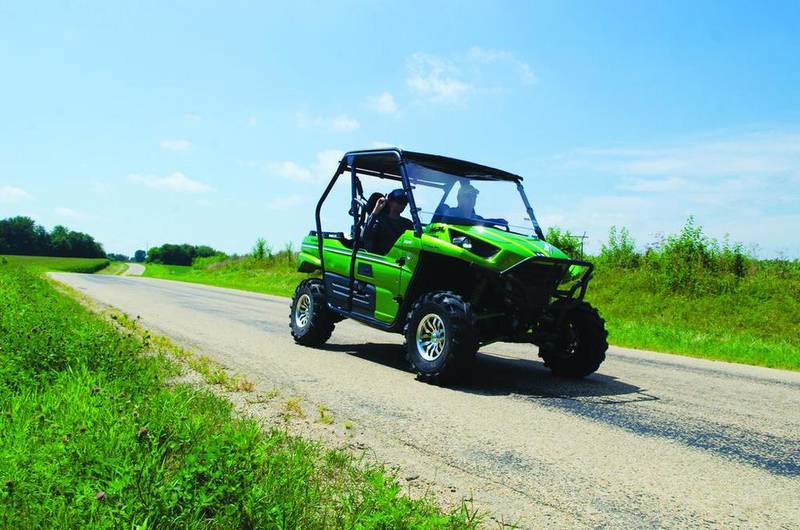 Hayden Goldie rides shotgun with Mark Imfeld on the Joe Stengel Trail in August. Local  UTV enthusiasts want to use the trail year-round, instead of just April through October, but snowmobilers are concerned  about the toll that wear and tear would take on the trails.