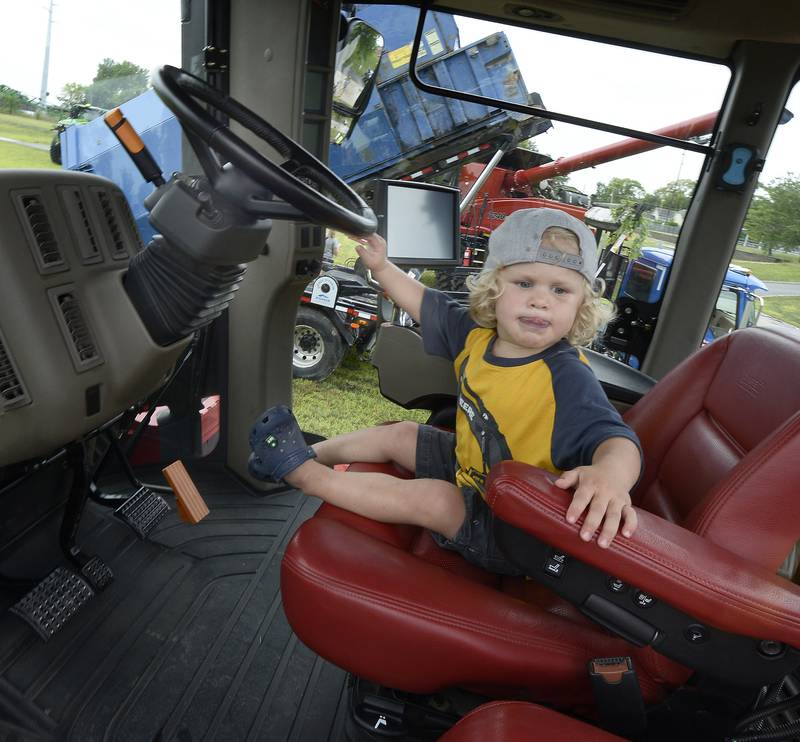 Teddy Chapman looks right at home and ready to farm as he sits in the cab of a tractor Sunday, Aug. 7, 2022, during the Touch A Truck event in Ottawa as part of Friendship Days.