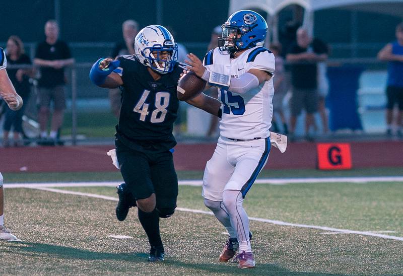 St. Charles North's Angelo Bradley (48) pressures Lake Zurich's Ashton Gondeck (15) in the backfield during a football game at St. Charles North High School on Friday, Sep 2, 2022.