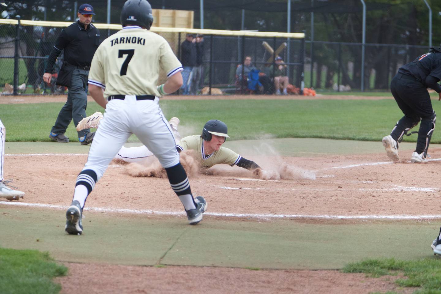 Sycamore's Lucas Winburn slides safely into home  plate against DeKalb at Kiswaukee College on Saturday, April 29, 2023 in Malta.