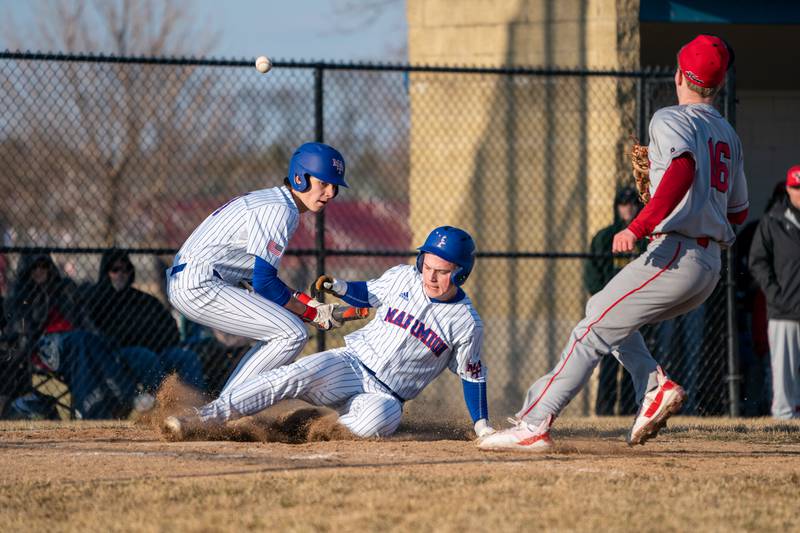 Yorkville's Tyler Gerrick (21) scores a run against Yorkville off of a wild pitch during a baseball game at Marmion High School in Aurora on Tuesday, Mar 28, 2023.