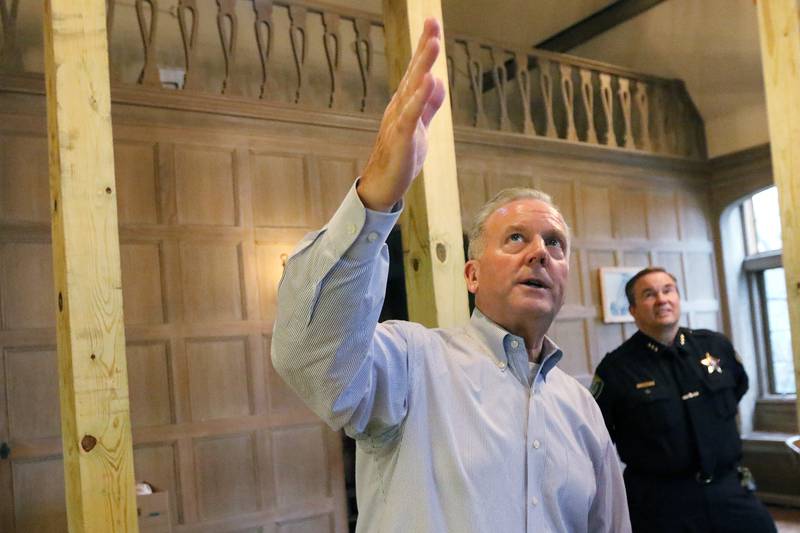Cary Mayor Mark Kownick, front, and Cary Police Chief Patrick Finlon talk Wednesday, Nov. 27, 2019, about the restoration inside the Hertz Estate Great Room, a room inside the building where the Cary Village Hall and Cary Police Department resided at the time. The police department and village administration will relocate to a vacant retention pond near the intersection of Industrial and Georgetown Drives.