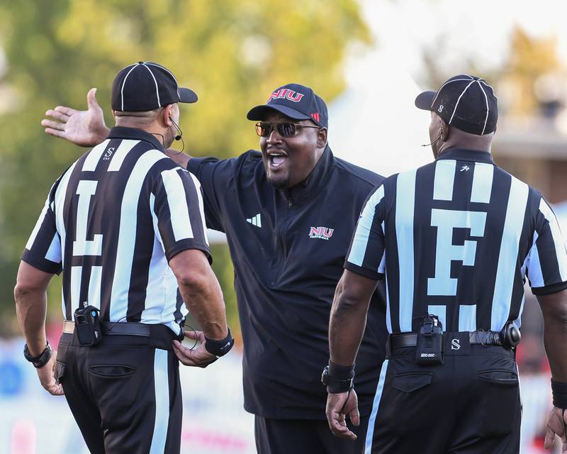 Northern Illinois University's head coach Thomas Hammock talks with officials for being called offsides after coming out of a timeout during the game on Saturday Sept. 27, 2025, held at Huskie Stadium in DeKalb.