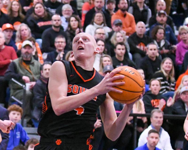 Wheaton Warrenville South's Ethan Farrell (14) makes a layup during the game on Friday Feb. 6, 2026, while traveling to take on Wheaton North High School.