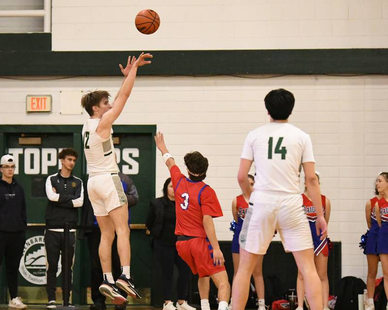 Glenbard West's Dominic Seaney, left, makes a three point shot during the first quarter while being defended by Glenbard South's Angjelos Salca (3) during district 87 Invite held at Glenbard West.