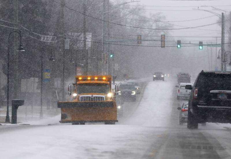 A McHenry Township snow plow tends to Johnsburg Road on Wednesday, Feb. 12, 2025, in Johnsburg as a winter storm starts to bring heavy snow to the McHenry County area.