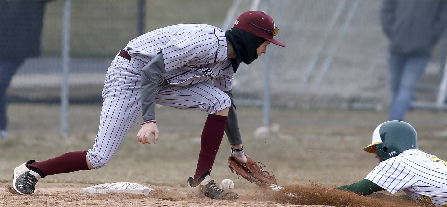 Richmond-Burton’s Johnny Larsen tries to tag Crystal Lake South’s Ryan Skwarek as Skwarek slides into third base during a nonconference baseball game Friday, March 24, 2023, at Crystal Lake South High School.