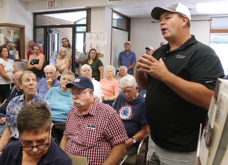 Shabbona resident Berkeley Boehne (right) asks a question at the Flewellin Memorial Library in Shabbona Monday, Aug. 5, 2024, to U.S. Rep. Lauren Underwood, D-Naperville, and Raphael Wahwassuck a tribal council member from the Prairie Band Potawatomi Nation. Underwood and Wahwassuck were on hand for a community conversation regarding the Prairie Band Nation Potawatomi Tribe land transfer in DeKalb County.
