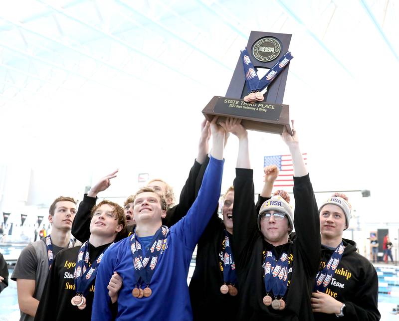 Lyons Township swimmers celebrate their third-place finish in the IHSA Boys Swimming and Diving Championships at FMC Natatorium in Westmont on Saturday, Feb. 26. 2022.