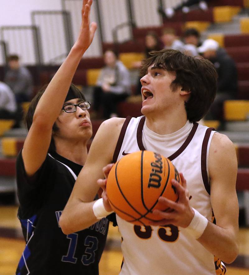 Richmond-Burton's Jace Nelson tries to drive to t the basket against Woodstock's Joesph Nitz during a Kishwaukee River Conference basketball game on Wednesday, Feb. 5, 2025, at Richmond-Burton High School.