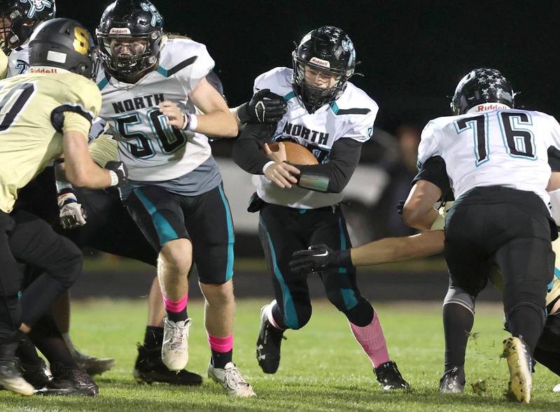 Woodstock North's Kaden Combs tries to get outside of the Sycamore defense during their game Friday Oct. 7, 2022, at Sycamore High School.