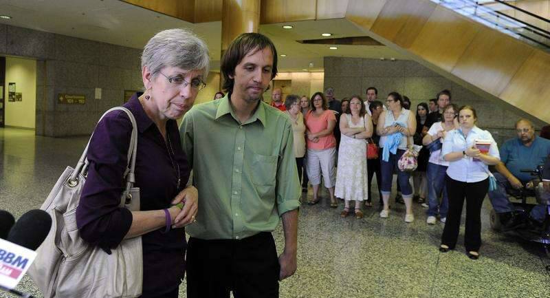 FILE – An emotional Jeff Engelhardt and his mother, Shelly, spoke with reporters in 2014 after a jury found D’Andre Howard guilty of murdering three members of their family in 2009. Howard was sentenced to life in prison without parole for the murders, plus 60 years for the attempted murder of Shelly, who still lives in Hoffman Estates.