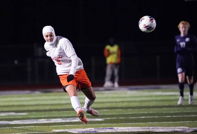 St. Charles East's Aiden Maloney (8) shoots the ball from midfield against New Trier during the class 3A St. Charles North Boys Soccer Supersectional match at St. Charles North High School on Wednesday, Nov. 1, 2023.