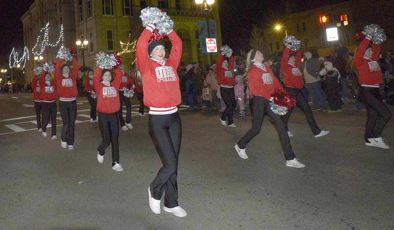 The Ottawa Township High Poms , spread cheer as go marching down La Salle St in Ottawa Friday during the Festival of Lights Parade.