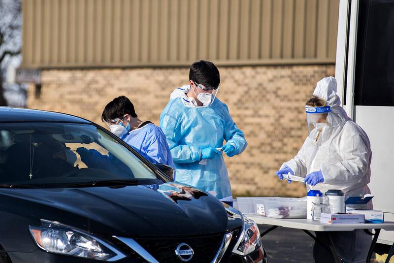 Maya Bowers (left), Michael Donovan an Anita Wahline work at the scene of a COVID-19 testing van in Dixon. The group HR Support was tasked to conduct the free test.