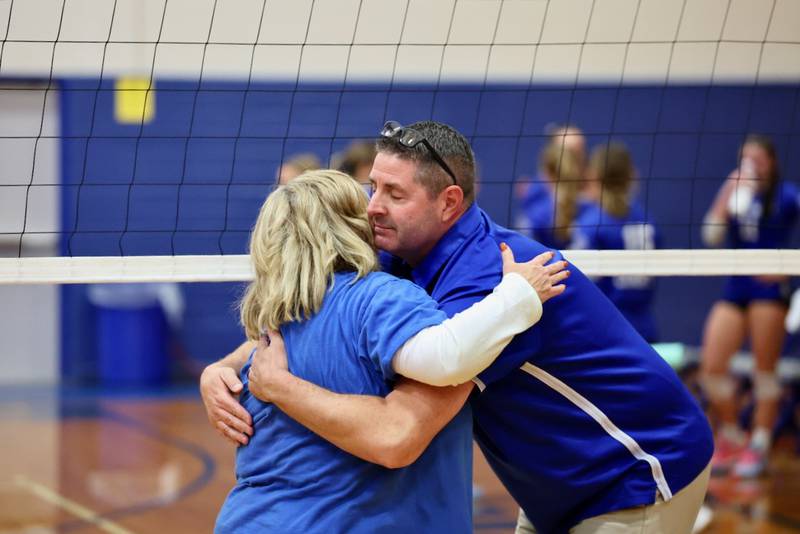 Princeton coach Andy Puck and Newman's Debbi Kelly embrace after Thursday's regional finals at Prouty Gym.