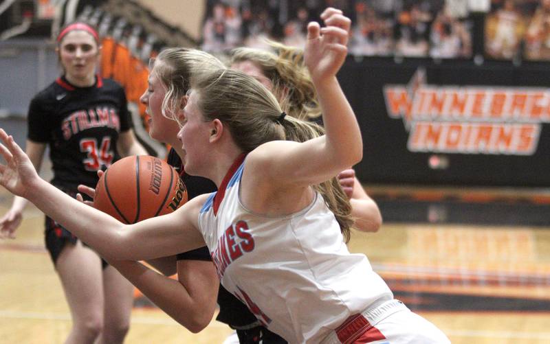 Marian Central’s Abbey Miner, front, battles Stillman Valley’s Mya Janssen in IHSA Class 2A Sectional girls basketball action at Winnebago Tuesday night.