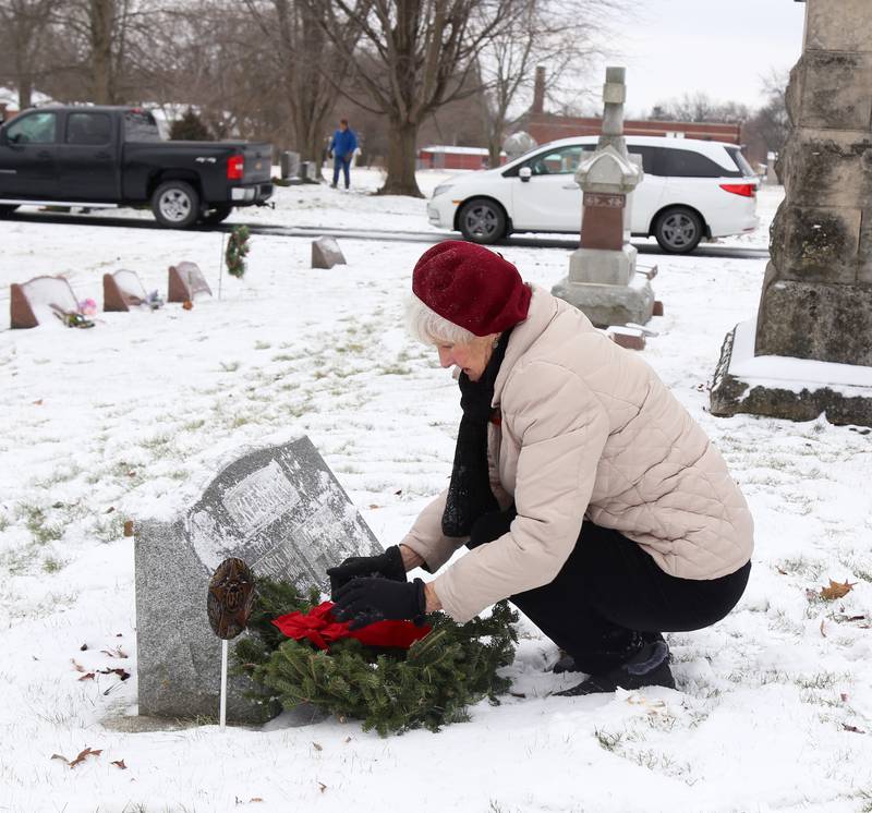 Susan Fous of Batavia places a wreath on the grave of Francis M. Keenan at St. Gall’s Cemetery in Elburn on Saturday, Dec. 17, 2022