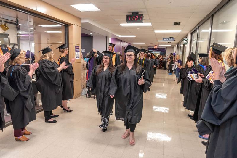 McHenry County College faculty and staff applaud the new graduates after the commencement ceremony on Saturday, May 14, 2022.