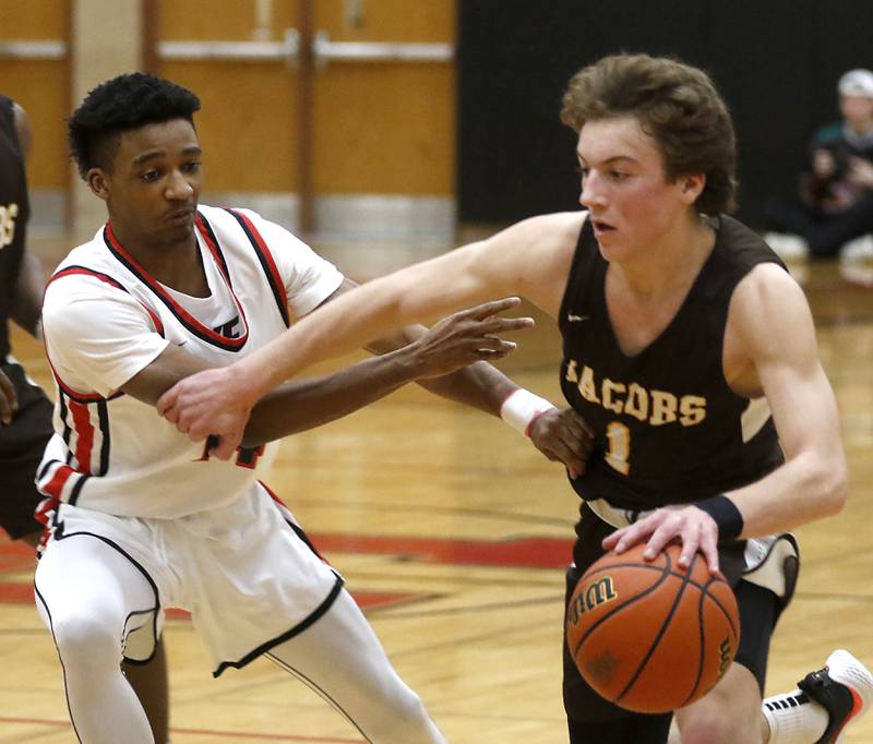 Jacobs' Ben Jurzak grabs Huntley's Bryce Walker\s arm as he drives to the basket during a Fox Valley Conference boys basketball game Tuesday, Jan. 24, 2023, at Huntley High School.