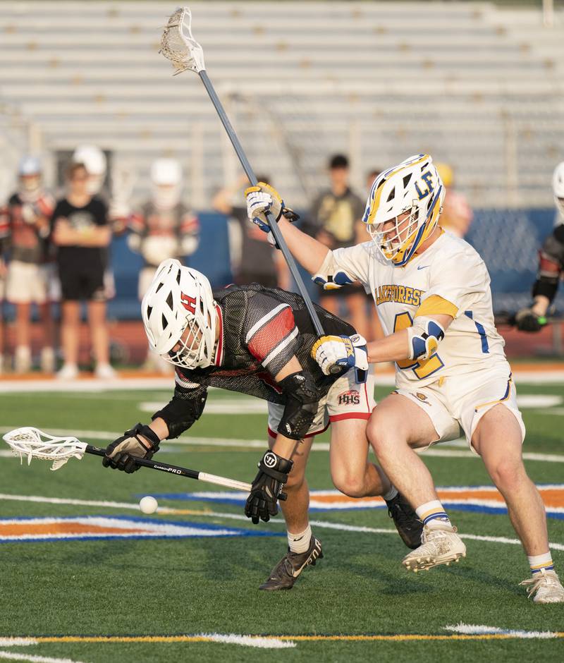 Huntley's Liam Manning and Lake Forest's John Carrabine battle for a loose ball during the boys lacrosse supersectional match on Tuesday, May 31, 2022 at Hoffman Estates High School.