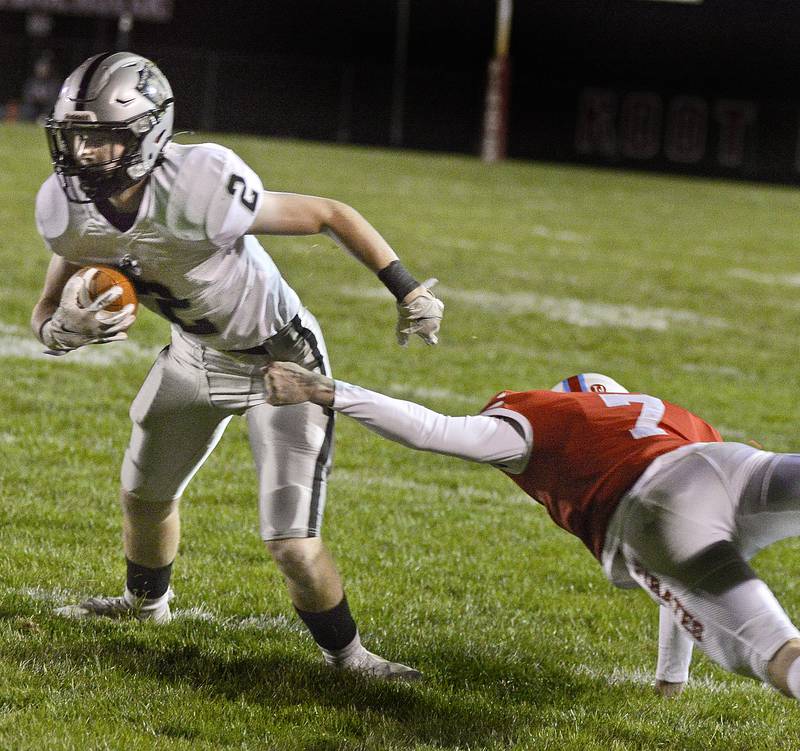 Ottawa's Dillan Quatrano attempts a one handed grasp to stop Kaneland's Johnny Spallasso on a run in the 1st quarter Friday at Ottawa on Oct 14, 2021.