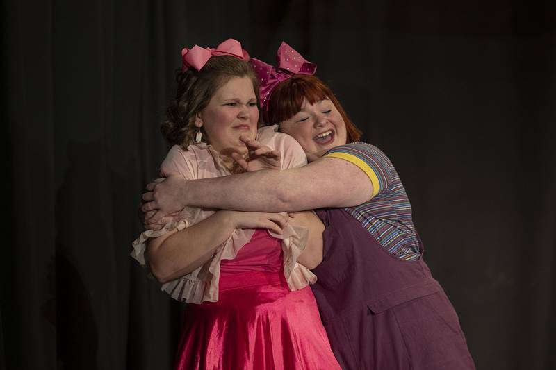 Junie, played by Jordann Langer-Fishman, hugs best friend Lucille, played by Bailey Dusing, during rehearsal of the Polo Area Community Theatre production of “Junie B. Jones: The Musical.”
