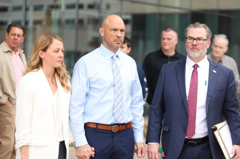 Heather and Edward Goewey stand by defense attorney Robert Bodach during a press conference outside Will County Courthouse. Edward Goewey, a Will County sheriff’s deputy currently on medical leave, is being charged with disorderly conduct accusing him of disturbing Mokena school officials when he insisted on the removal of a student he believed made a shooting threat at St. Mary Catholic school. Monday, April 11, 2022, in Joliet.