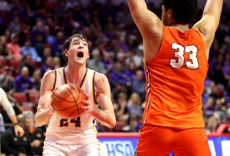 Downers Grove North’s Aidan Akkawi attempts a shot from under the basket during the Class 4A Normal Supersectional game against Normal Community on Monday, March 4, 2024.