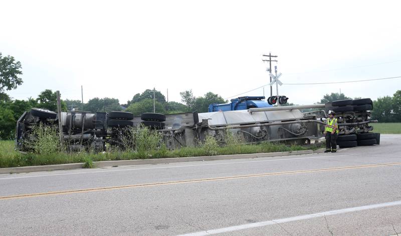 Wallace firefighters work the scene of an overturned sand hauler at the intersection of North 15th Road and U.S. Route 6 on Wednesday, July 9, 2025 in Ottawa. The semi overturned on the train tracks. La Salle County Sheriff and Ottawa Police assisted with the crash.