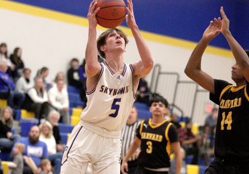 Johnsburg’s Kyle Patterson works under the net against Harvard in varsity boys basketball at Johnsburg Saturday.