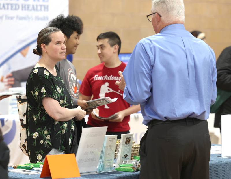 Attendees visit a booth during the DeKalb Chamber of Commerce’s Local Showcase and Job Fair Thursday, April 25, 2024, at the DeKalb Sports and Recreation Center.