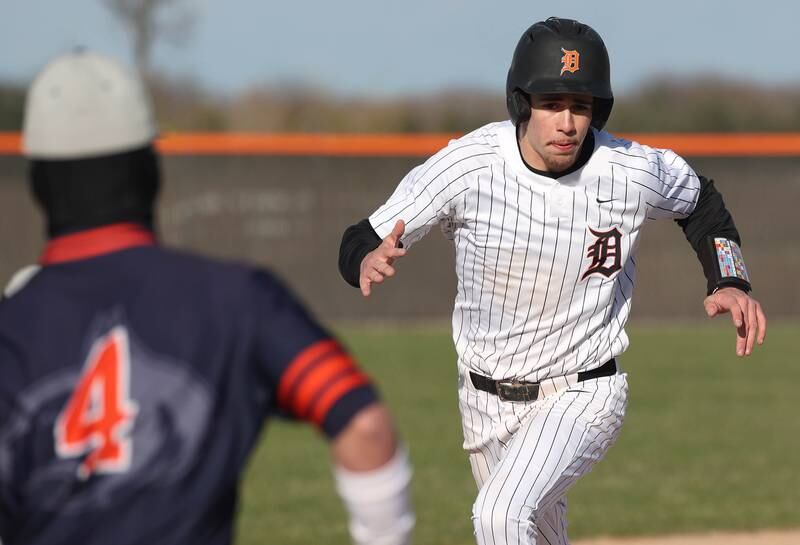 DeKalb's Cole Latimer heads for third Tuesday, April 15, 2025, during their game against Naperville North at DeKalb High School.