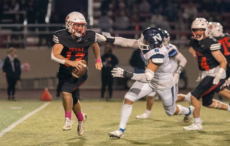 Nazareth Academy's Gabe Kaminski (5) pressures Benet Academy's Jacob Hoeppel (12) during a football game at Benedictine University in Lisle on Friday, Oct 21, 2022.