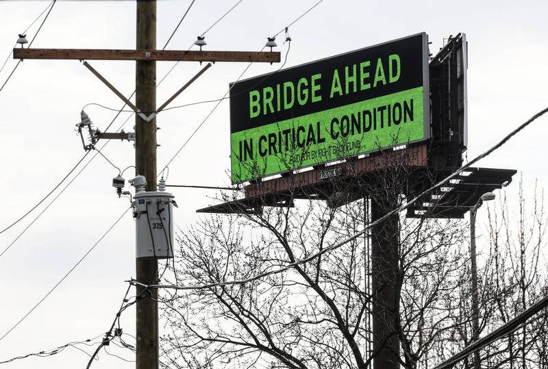 A sign sponsored by Local 150 of the International Union of Operating Engineers warns motorists who drive over the Interstate 80 bridge on Tuesday, Feb. 26, 2019, across the Des Plaines River in Joliet, Ill.