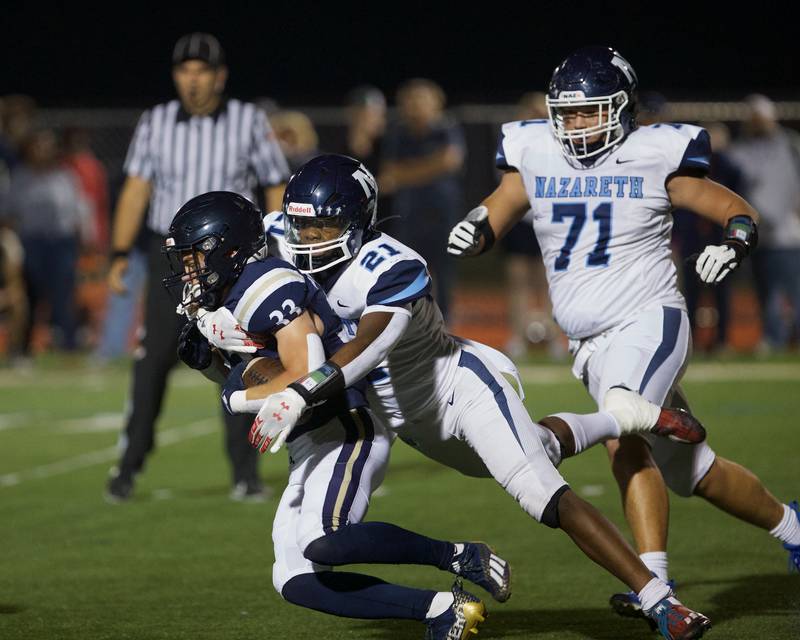 IC Catholic's Joey Gliatta is tackled by Nazareth's Lesroy Tittle on Friday, Sept.15,2023 in Elmhurst.