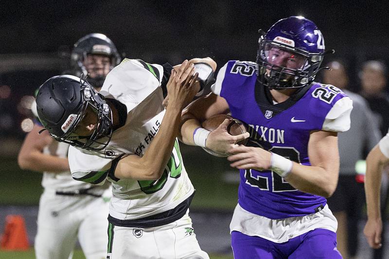 Dixon’s Aiden Wiseman breaks a tackle against Rock Falls’ Luke Hacker Friday, Oct. 21, 2022.