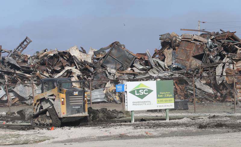 A Bobcat moves debris near the entrance of LSC Environmental Products (formally Phoenix Paper Products) on Monday, Feb. 5, 2024 near Lostant. This comes two-weeks after a massive three-alarm fire destroyed the business. Lostant Fire Department has been out to the site several times since the fire for rekindles.