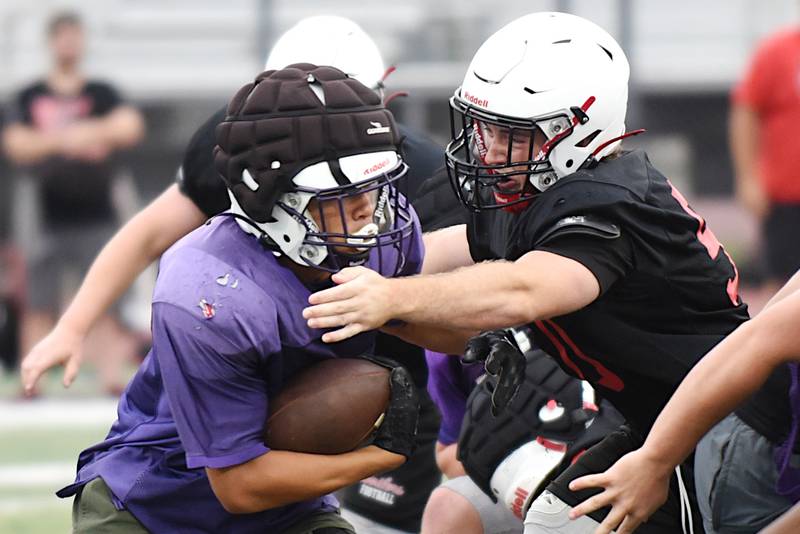 Wilmington's Hunter Kaitchuck, left, looks to run around Bradley-Bourbonnais' Nathan Lindsey during a joint summer workout at Bradley-Bourbonnais Wednesday, July 16, 2025.