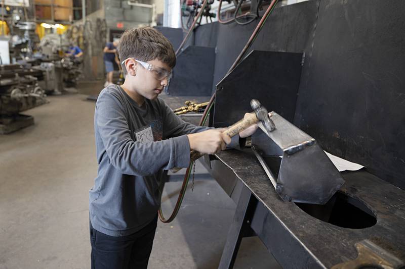 Bryce Leighton, 12, of Morrison flattens his tool box Thursday, July 13, 2023 at the WACC trades camp.