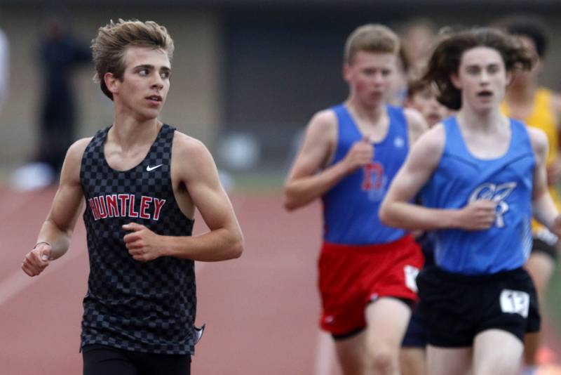 Huntley’s Tommy Nitz looks over as he laps runners onhis way to winning the 3200 meter run during the Fox Valley Conference Boys Track and Field Meet on Thursday, May 9, 2024, at Huntley High School.