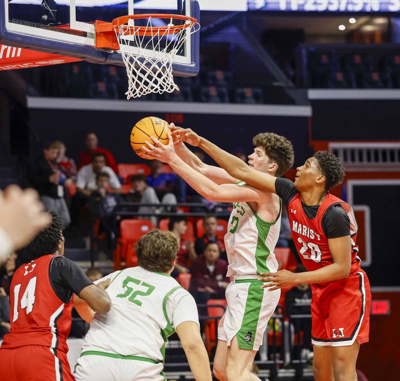 York’s Hunter Stepanich (50) is fouled by Marist's Kendall Meyers (20) on the way to the hoop during the IHSA Class 4A boys basketball state semifinal Friday, March 13, 2026 at the State Farm Center in Champaign.