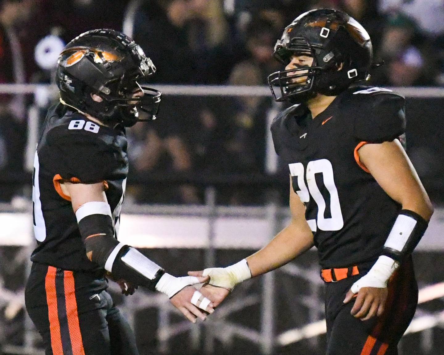 Sandwich's Diego Gomez (20) gets congratulated by teammate Jeffrey Ashley (88) after scoring a touchdown on Friday Oct. 25, 2024, while taking on Marengo held at Sandwich High school.