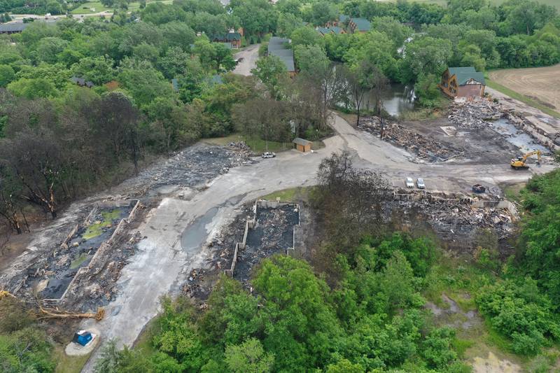 The foundations of three sets of cabins, dead trees, and burnt vehicles are all that remains after a major fire swept through the Grand Bear Resort and set fire to 28 cabins on Tuesday, May 31, 2022 in Utica.