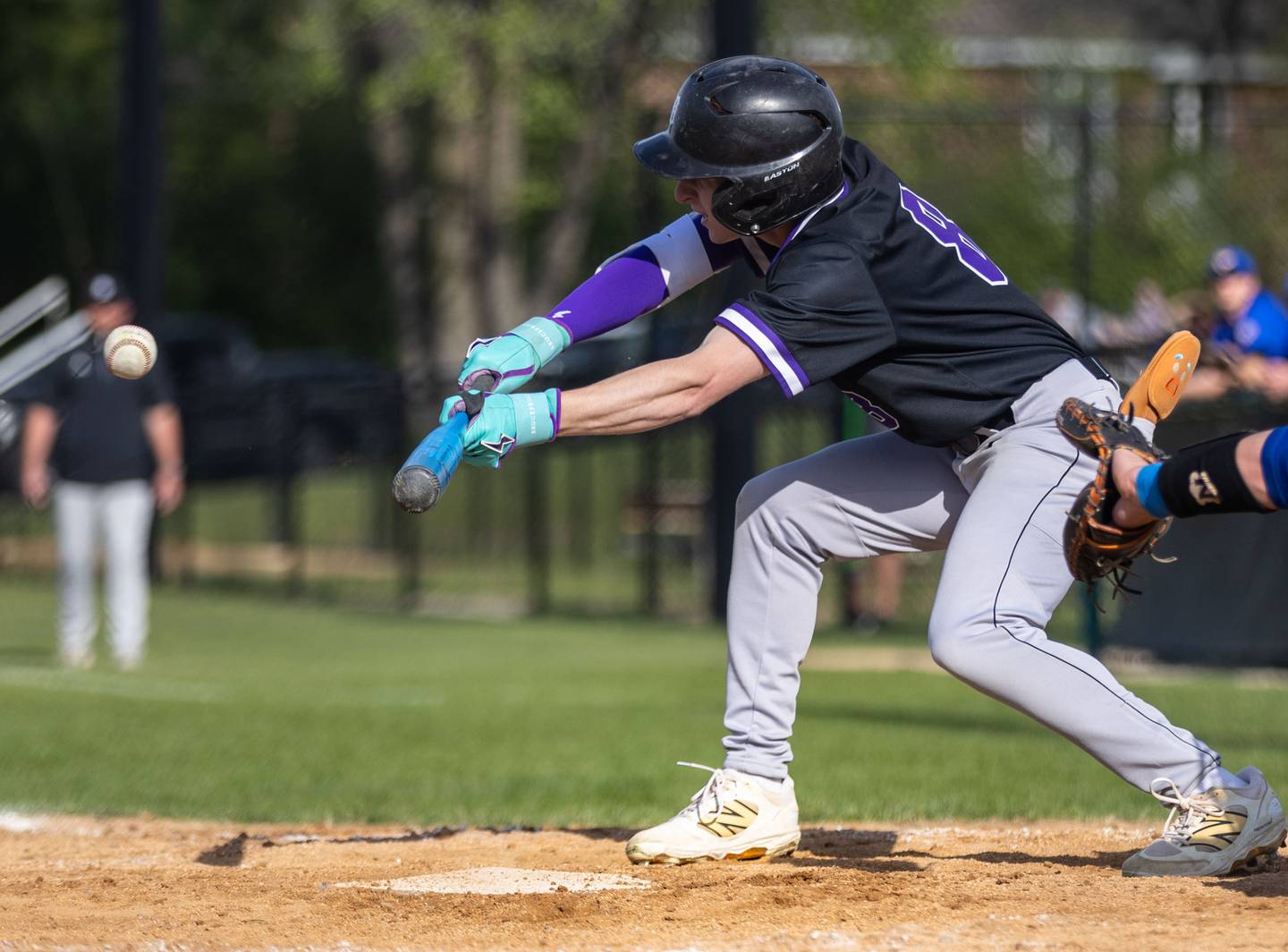 Downer’s Grove North outfielder Drake Cosenza bunts during a game against Lyons Township in Downers Grove on Monday, May 12, 2025.