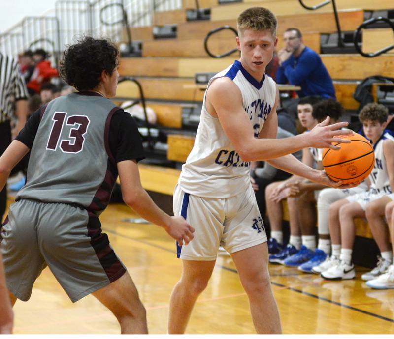 Newman's George Jungerman (13) keeps the ball away from Marengo's Myles Aukes (13) on Friday, Nov. 29, 2024 at the Oregon Thanksgiving Tournament held at the Blackhawk Center in Oregon.
