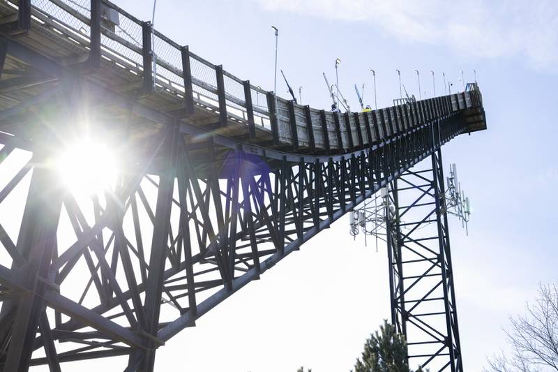 Ski jumpers make the long journey up to the top of the ski jump during the Norge Annual Winter Ski Jump Tournament on Sunday, January 26, 2025 at the Norge Ski Jump in Fox River Grove.