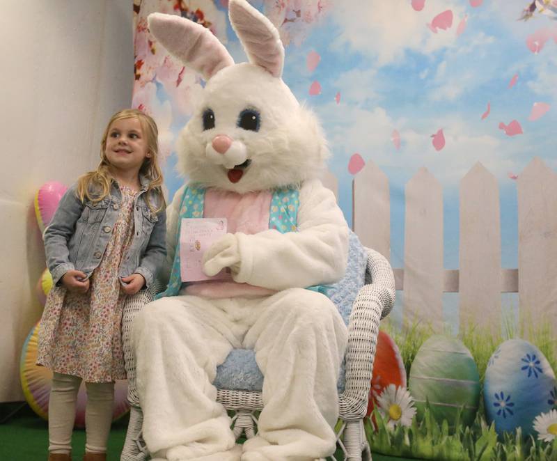 Olive Zemanec of Utica smiles while having her photo taken with the Easter Bunny during the Spring Valley Easter egg hunt presented by Upscale Resale and Grow on Saturday, March 23, 2024 at Hall High School.
