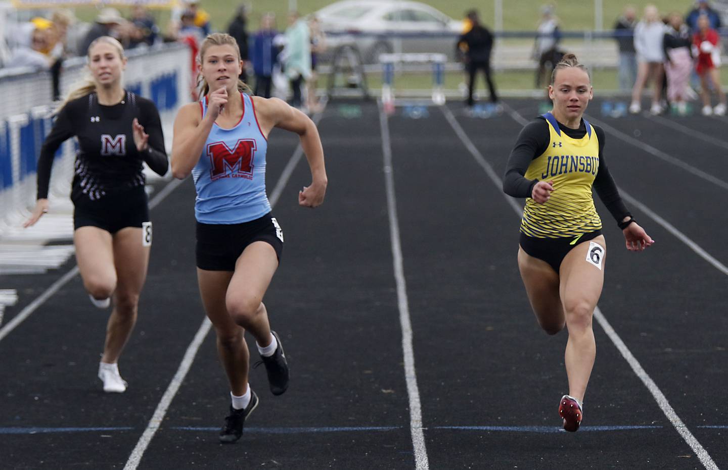 Marengo’s Ava Frederick, Marian Central’s Addie Leitzen and Johnsburg’s Hope Klosowicz race to finish line in the 100 meter dash during the IHSA Class 2A Johnsburg Girls Track and Field Sectional Meet on Wednesday, May 13, 2026, at Johnsburg High School.